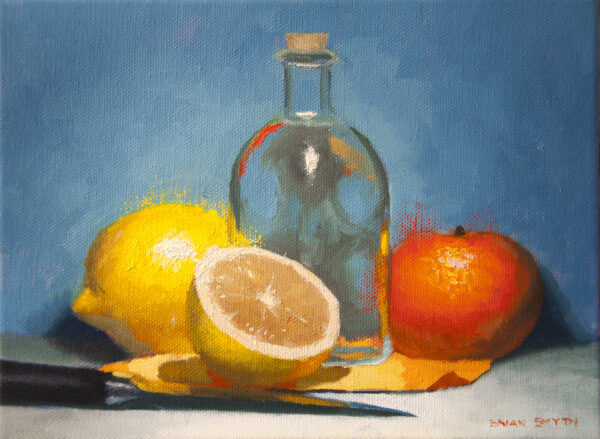 Lemons, orange, and glass bottle