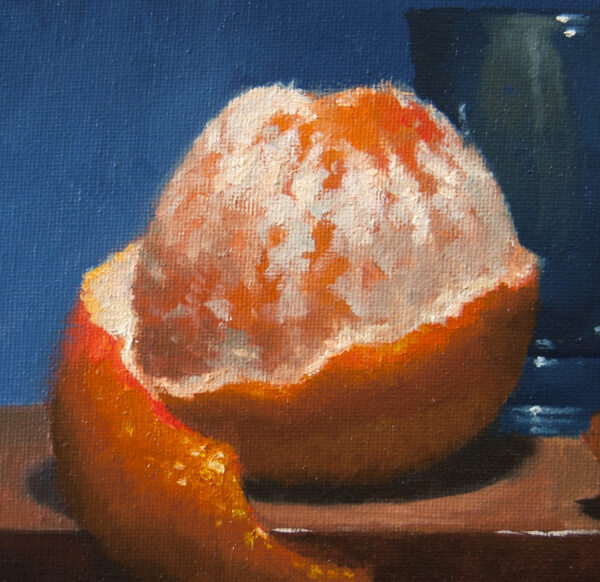 Peeled orange and a glass