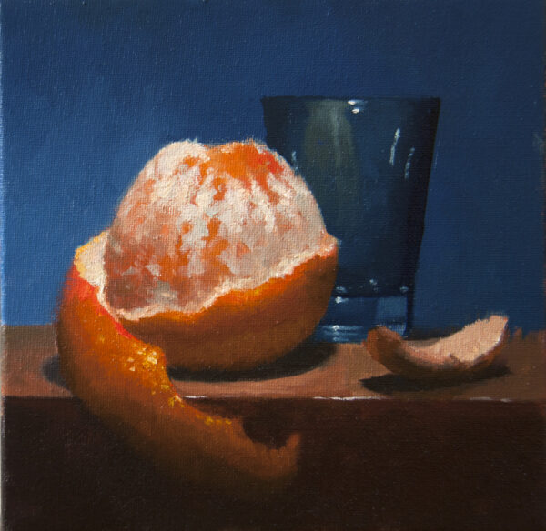 Peeled orange and glass